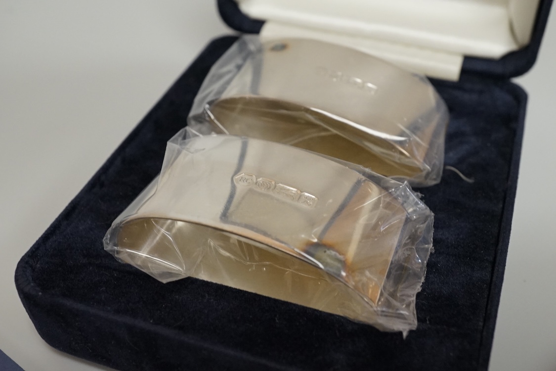 Two boxed pairs of Elizabeth II silver napkin rings by Carr's of Sheffield, Sheffield, 1997.